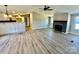 Open living room with kitchen and fireplace at 9763 Knightbridge Dr, Concord, NC 28025