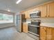 Modern kitchen with stainless steel appliances and light wood cabinets at 11316 Vista Canyon Dr, Charlotte, NC 28226