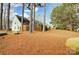 View of backyard with pine straw and tall trees at 11507 Delores Ferguson Ln, Charlotte, NC 28277