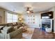 Relaxing living room with fireplace and large TV at 11507 Delores Ferguson Ln, Charlotte, NC 28277