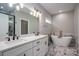 Bathroom with double vanity, soaking tub, marble tile, and modern lighting at 1533 Weatherwood Dr, Lincolnton, NC 28092