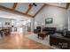 Open living room with kitchen, vaulted ceiling, hardwood floors, and leather sofas at 1533 Weatherwood Dr, Lincolnton, NC 28092