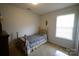 Small bedroom with brass bed frame and window with blinds at 2038 Mallard Creek Dr, Rock Hill, SC 29732
