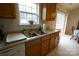 Kitchen sink and dishwasher with oak cabinets and sliding door at 2038 Mallard Creek Dr, Rock Hill, SC 29732