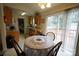 Kitchen with wood cabinets, white appliances, and dining area at 2038 Mallard Creek Dr, Rock Hill, SC 29732