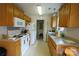 Galley kitchen with wood cabinets and white appliances at 2038 Mallard Creek Dr, Rock Hill, SC 29732