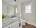 Modern bathroom with granite countertops, a white vanity, and stylish fixtures at 4739 Whispering Oaks Dr, Charlotte, NC 28213