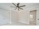 Corner bedroom featuring a ceiling fan, multiple windows, and two closets, offering ample space at 4739 Whispering Oaks Dr, Charlotte, NC 28213