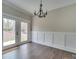 Bright dining area features hardwood floors, modern wainscoting, and elegant lighting, ideal for comfortable Gathering meals at 4739 Whispering Oaks Dr, Charlotte, NC 28213