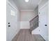 Bright foyer showcasing wood-look floors, a staircase, and paneled walls at 4739 Whispering Oaks Dr, Charlotte, NC 28213