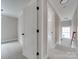 Hallway view highlighting the seamless transition between living spaces and carpeted floors at 4739 Whispering Oaks Dr, Charlotte, NC 28213