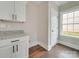 Well-lit pantry features granite countertops, white cabinets, and a window, offering ample storage space at 4739 Whispering Oaks Dr, Charlotte, NC 28213