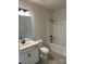 Modern bathroom featuring a sleek vanity, dark hardware, and a shower-tub combination at 6319 Honor Ave, Midland, NC 28107