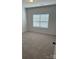 Bright bedroom with plush carpet and a large window, creating a cozy atmosphere at 6319 Honor Ave, Midland, NC 28107