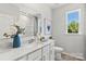 Bright bathroom with quartz countertop, white cabinets, and a window at 7108 Brookview Ln, Sherrills Ford, NC 28673