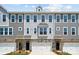 Three-unit townhome building with gray siding, white garage doors, and stone accents at 7108 Brookview Ln, Sherrills Ford, NC 28673