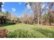 Spacious backyard with lush lawn and wooded backdrop at 9890 Legolas Ln, Charlotte, NC 28269