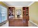 Spacious home office with built-in bookshelves and a large desk at 9890 Legolas Ln, Charlotte, NC 28269