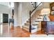 Elegant staircase with hardwood floors and white railings at 9890 Legolas Ln, Charlotte, NC 28269