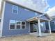 A covered patio extends from the rear of this two-story home, with an open backyard at 1432 Mccollum N St, Monroe, NC 28112