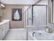 Modern bathroom featuring a tub, glass-enclosed shower, and double vanity at 1432 Mccollum N St, Monroe, NC 28112