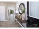 Welcoming foyer with wood-look flooring, console table, and a stylish round mirror at 1432 Mccollum N St, Monroe, NC 28112