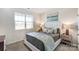 Bright bedroom with plush carpet, natural light from the window, and an inviting bed at 1447 Honey Trl, Monroe, NC 28112