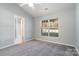 Spacious bedroom with grey carpet, window, and access to bathroom at 1630 Hardy Dr, Rock Hill, SC 29732