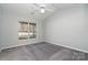 Bright bedroom with ceiling fan, grey carpet, and large window at 1630 Hardy Dr, Rock Hill, SC 29732