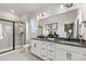 Elegant bathroom with double sinks, framed mirrors, modern fixtures, and a walk-in shower with glass door at 1746 Blanche St, Charlotte, NC 28262