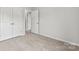 Bright bedroom featuring white walls, neutral carpet and a double door closet at 1750 Blanche St, Charlotte, NC 28262