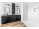 Modern bathroom with double vanity, black cabinetry, and marble shower at 211 Chestnut St, Shelby, NC 28150