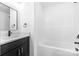 Bathroom with black cabinet vanity, and a modern bathtub-shower combination at 211 Chestnut St, Shelby, NC 28150