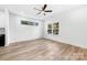 Bright bedroom features wood-look floors, two windows, and a ceiling fan at 211 Chestnut St, Shelby, NC 28150