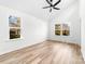 Bedroom featuring wood-look floors, vaulted ceiling, and two windows at 211 Chestnut St, Shelby, NC 28150