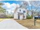 Newly renovated modern home featuring white siding and a smooth concrete driveway at 211 Chestnut St, Shelby, NC 28150