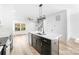 Kitchen island with faucet, stainless appliances, and view to living room at 211 Chestnut St, Shelby, NC 28150