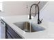 Stainless steel sink with black faucet and quartz countertop in a modern kitchen island at 211 Chestnut St, Shelby, NC 28150