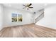 Bright living room with hardwood floors, a large window, and modern ceiling fan at 211 Chestnut St, Shelby, NC 28150