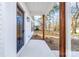 Close-up of a front porch featuring stained wood columns and modern exterior lighting at 211 Chestnut St, Shelby, NC 28150