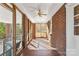 Cozy screened porch with brick floors and ceiling fan at 223 W 9Th St, Newton, NC 28658