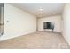 Bonus room with large TV, carpet flooring, and access to staircase at 2548 Flintshire Ln, Gastonia, NC 28056