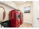 Convenient laundry room with washer, dryer, and shelving at 2548 Flintshire Ln, Gastonia, NC 28056