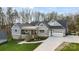 Gray farmhouse with a metal roof and landscaping at 324 Patternote Rd, Mooresville, NC 28117