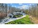 Aerial view of a home with a boat in the garage and a large yard at 324 Patternote Rd, Mooresville, NC 28117