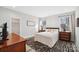 Bright bedroom with a queen-size bed and wood furniture at 324 Patternote Rd, Mooresville, NC 28117