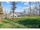 House exterior showcasing a long covered porch and wooded setting at 324 Patternote Rd, Mooresville, NC 28117