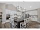 Modern kitchen with white cabinets, large island, and stainless steel appliances at 324 Patternote Rd, Mooresville, NC 28117