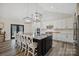 Kitchen with a large island, white cabinets and black countertops at 324 Patternote Rd, Mooresville, NC 28117