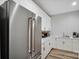 Modern kitchen with stainless steel refrigerator and white cabinets at 324 Patternote Rd, Mooresville, NC 28117